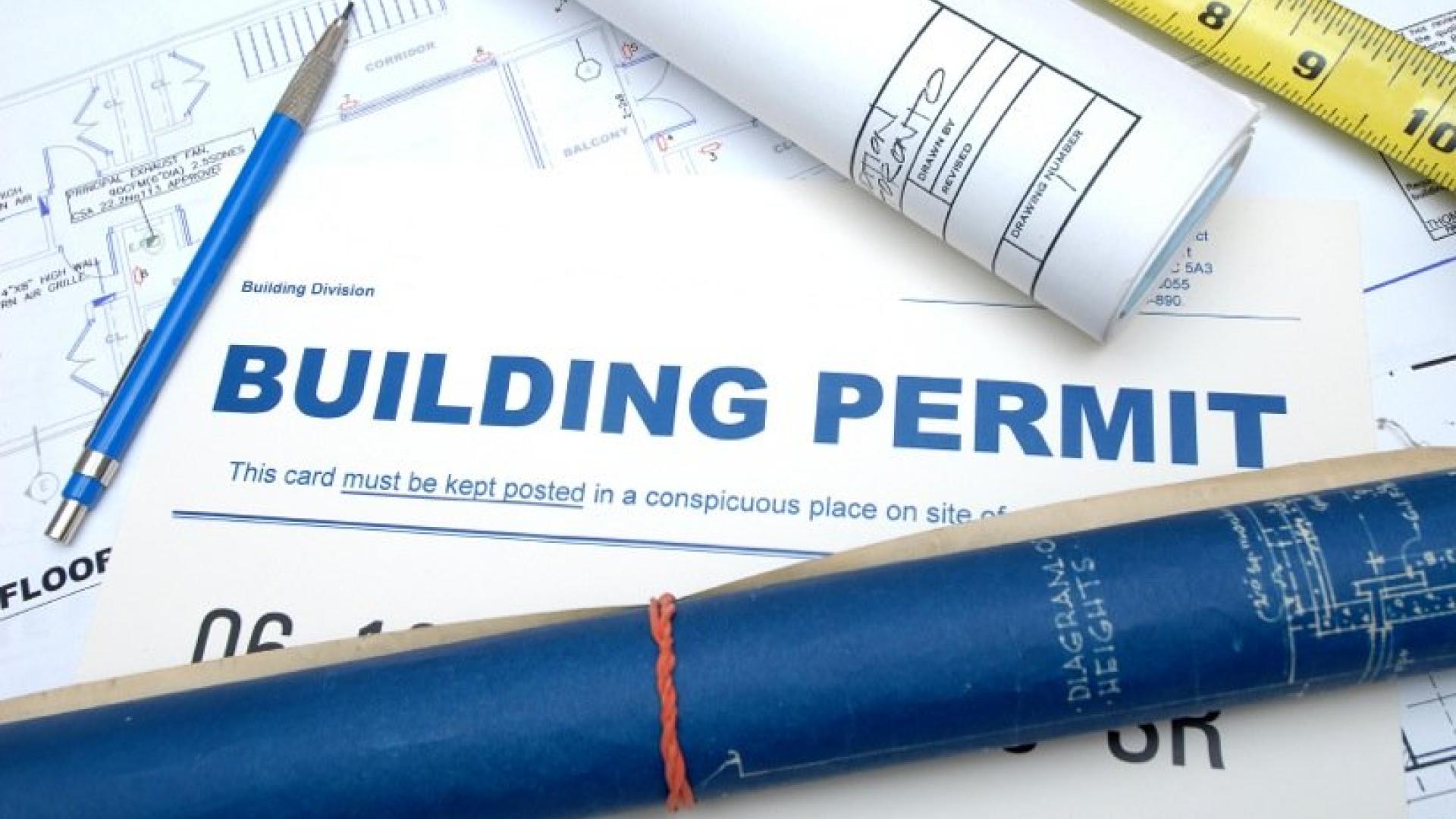 Building permit and tape measure