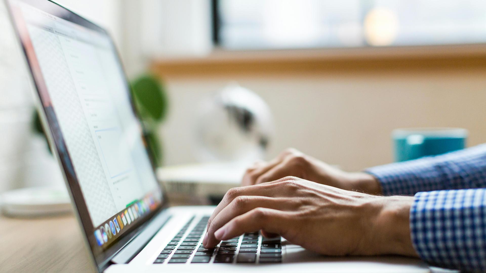 Person typing on laptop