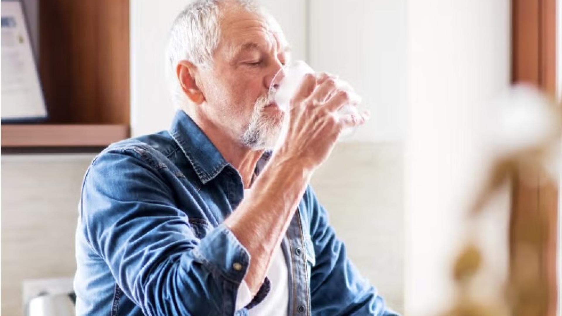 Extreme heat white-haired man drinking water