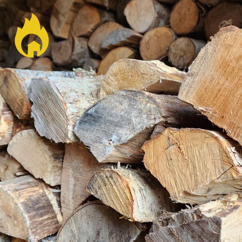 Close-up of a neatly stacked pile of cut firewood logs with a fire safety symbol.
