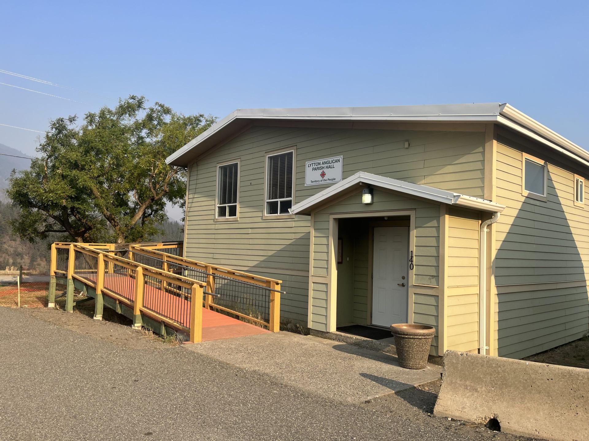 Lytton Anglican Parish Hall building with a wheelchair-accessible ramp and a clear blue sky.