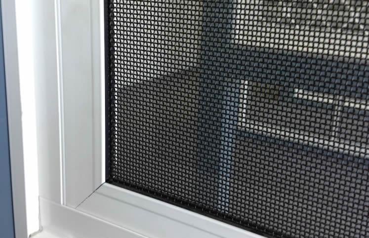 Close-up of a window screen showing its fine mesh.